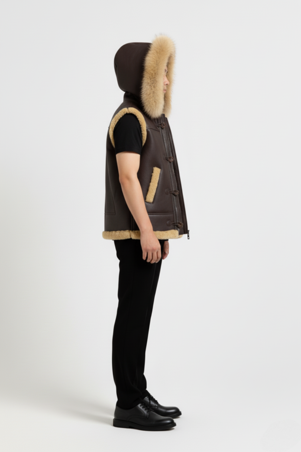 Side profile of Maverick Magnus shearling vest showing deep armhole cut and thick hood silhouette. Maverick Jacket.