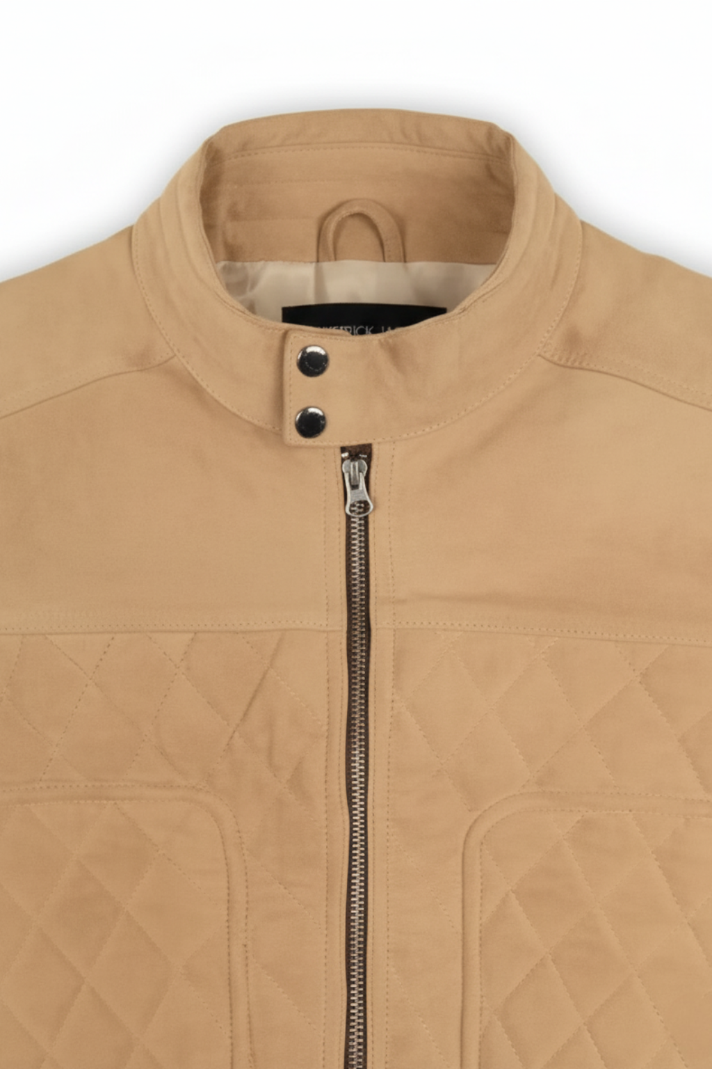 Macro shot of soft tan suede texture with channel quilting and metal zipper hardware on vest. The Leo Maverick Jacket.
