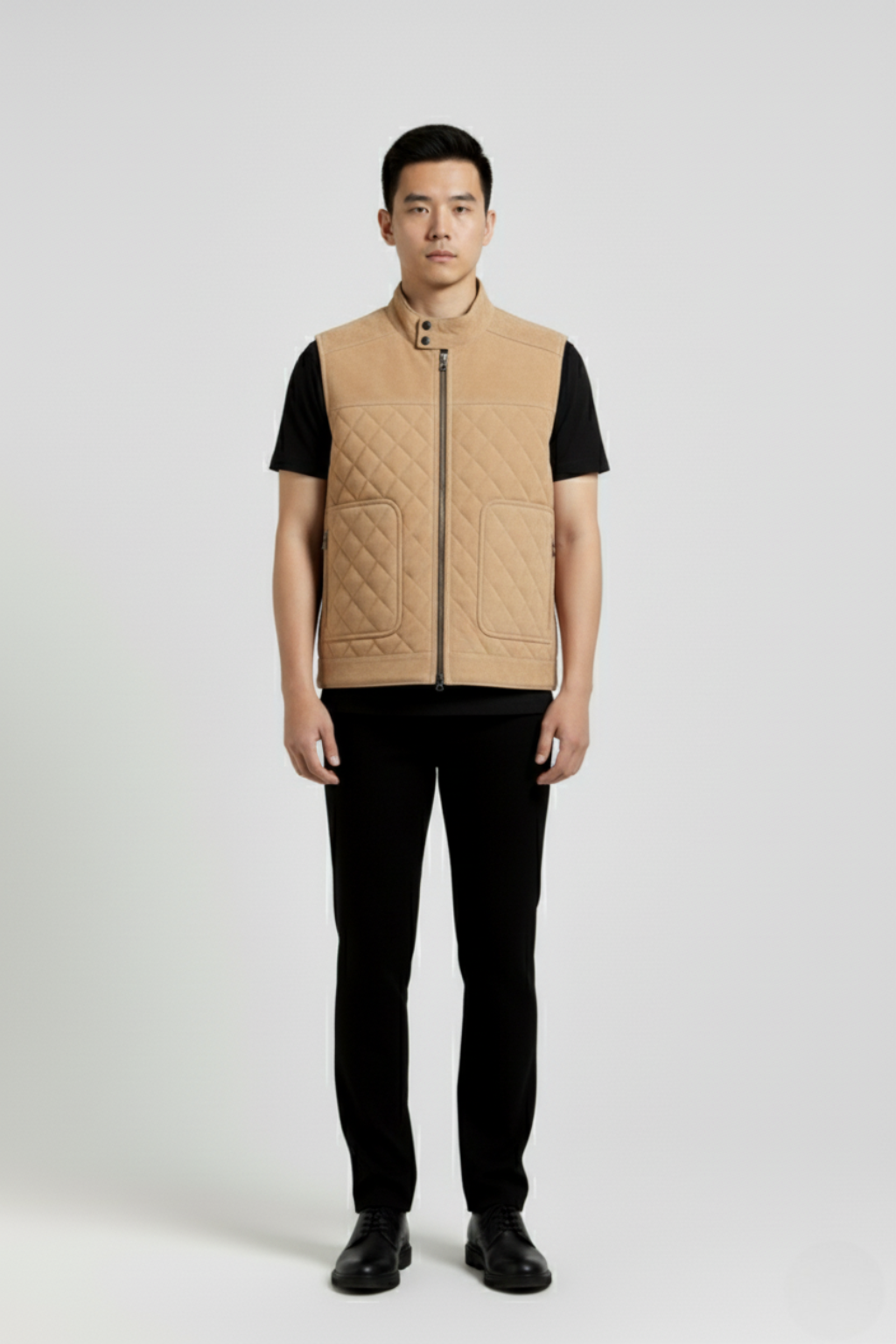Male model wearing Maverick Leo suede quilted vest, regular fit, styled over a white long-sleeve tee with dark indigo denim jeans. Maverick Jacket.