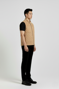 Side profile of Maverick Leo suede quilted vest showing deep armhole cut and puffed quilted silhouette. Maverick Jacket.