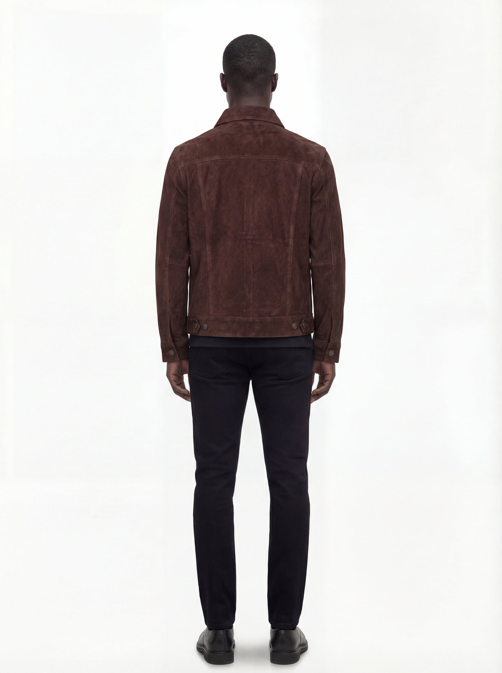 Rear view of male model wearing Maverick Callum suede trucker jacket showing tailored shoulder fit and clean back paneling. Maverick Jacket.