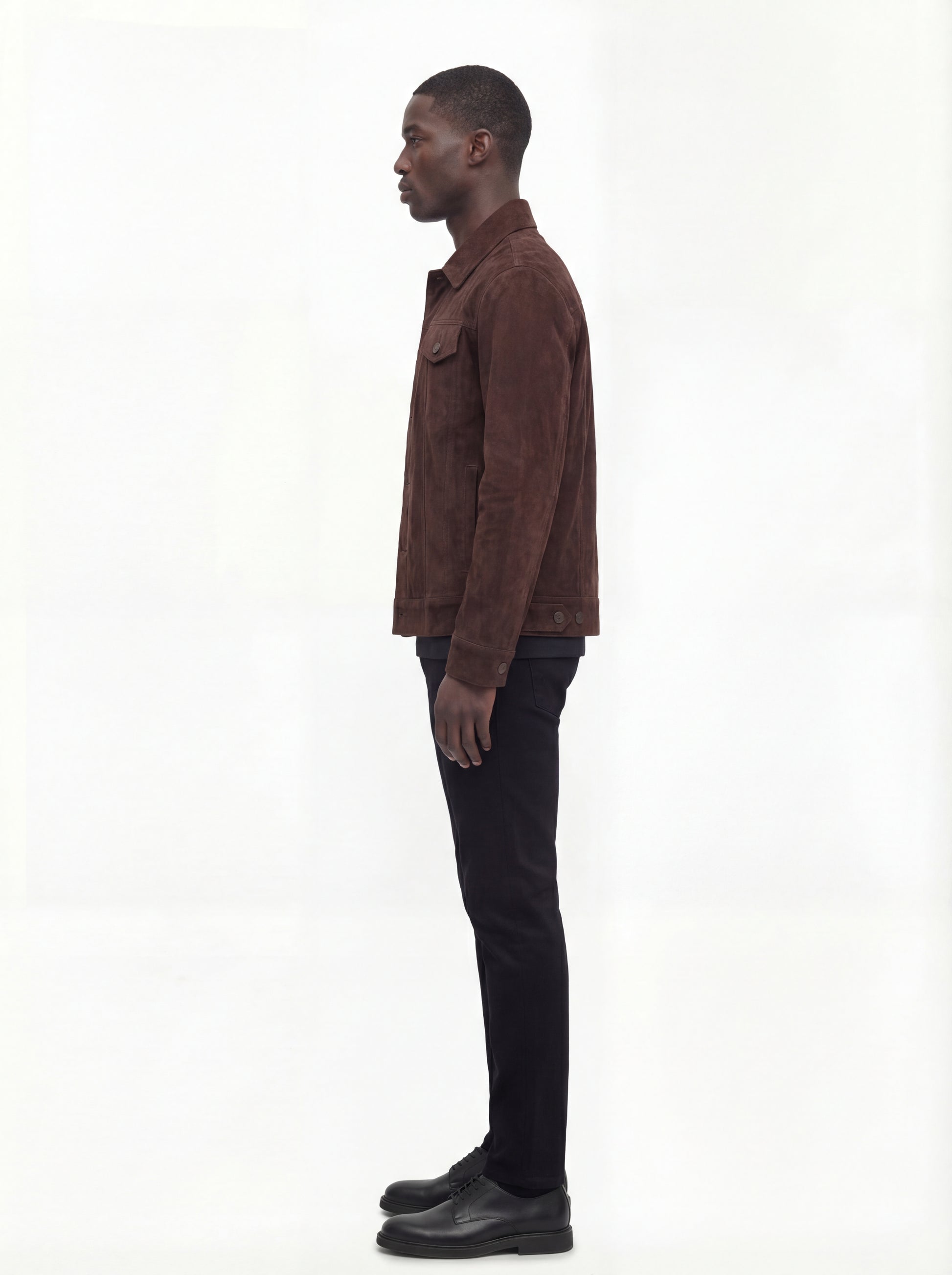 Side profile of Maverick Callum suede trucker jacket showing sleeve cuff structure and straight torso silhouette. Maverick Jacket.