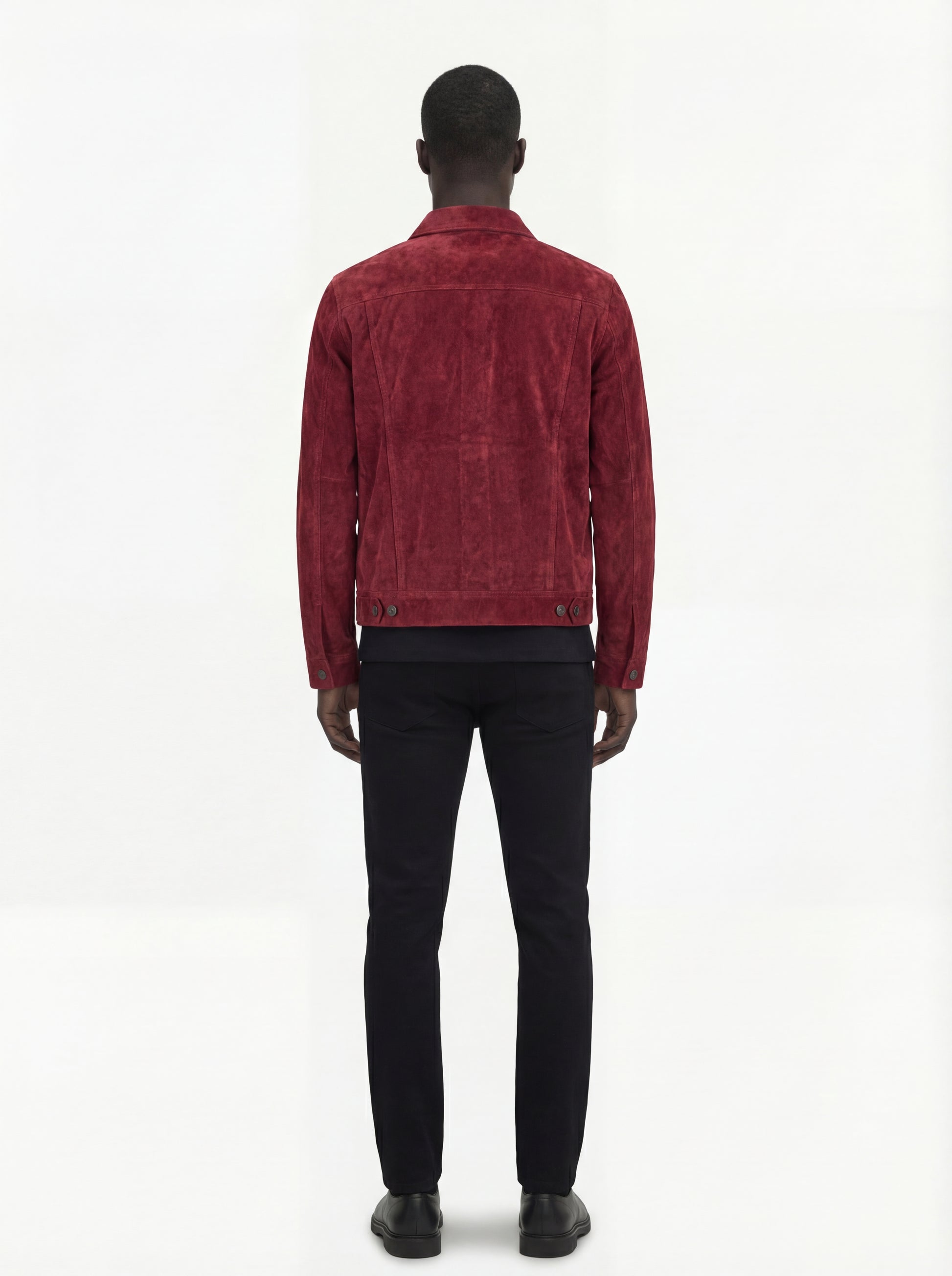 Rear view of male model wearing Maverick Strider suede trucker jacket showing tailored shoulder fit and clean back paneling. Maverick Jacket.