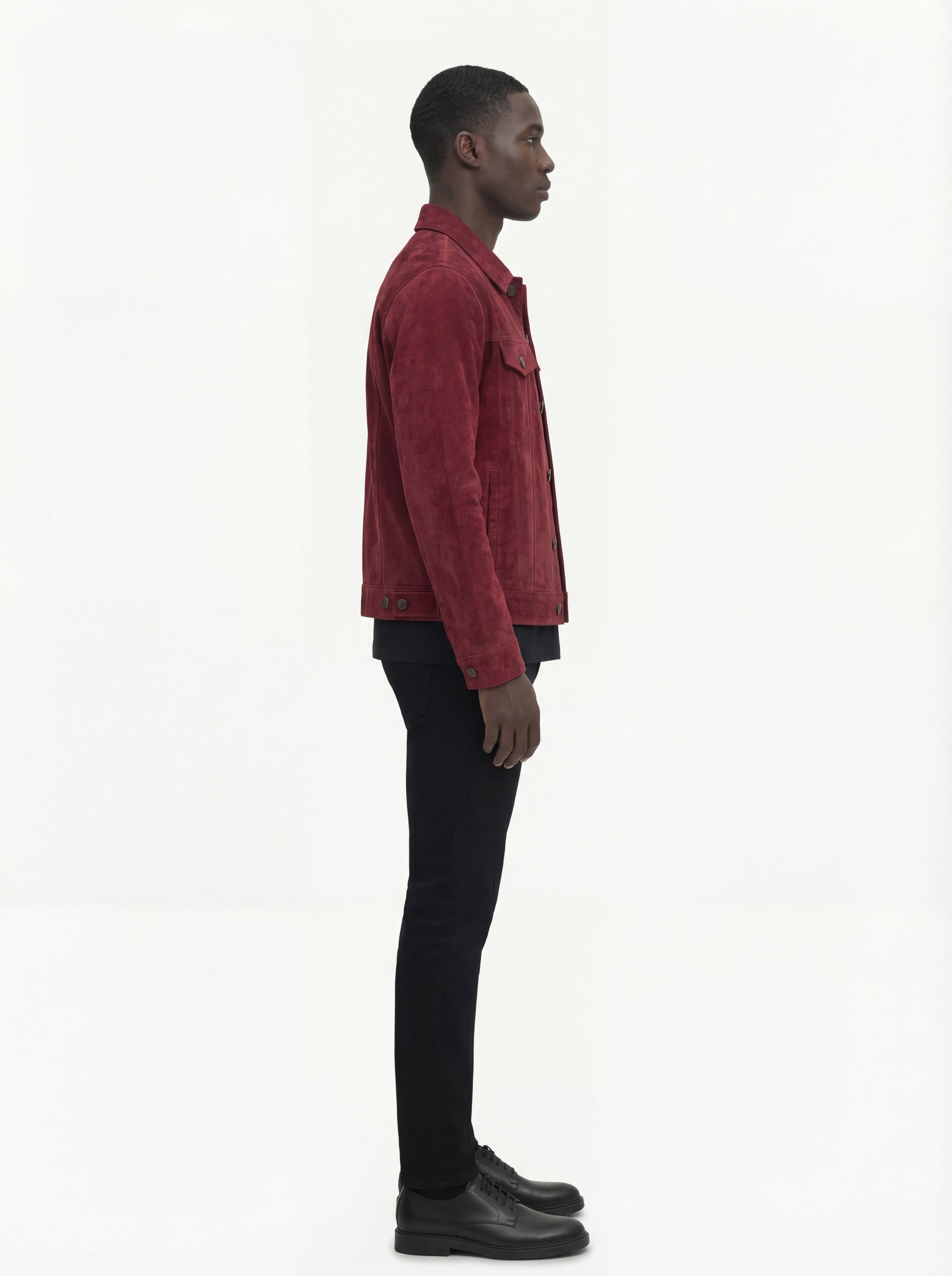 Side profile of Maverick Strider suede trucker jacket showing sleeve cuff structure and straight torso silhouette. Maverick Jacket.