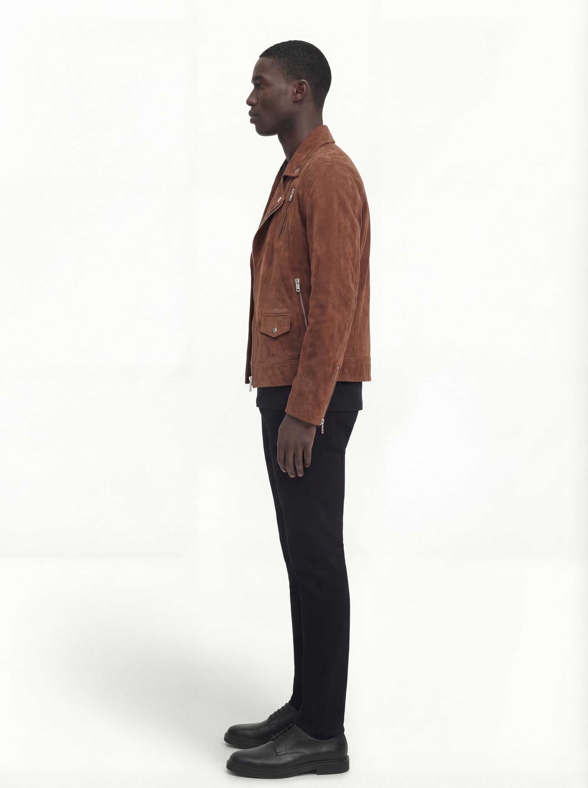 Side profile of Maverick Canyon suede biker jacket showing zippered sleeve cuffs and cropped silhouette. Maverick Jacket.