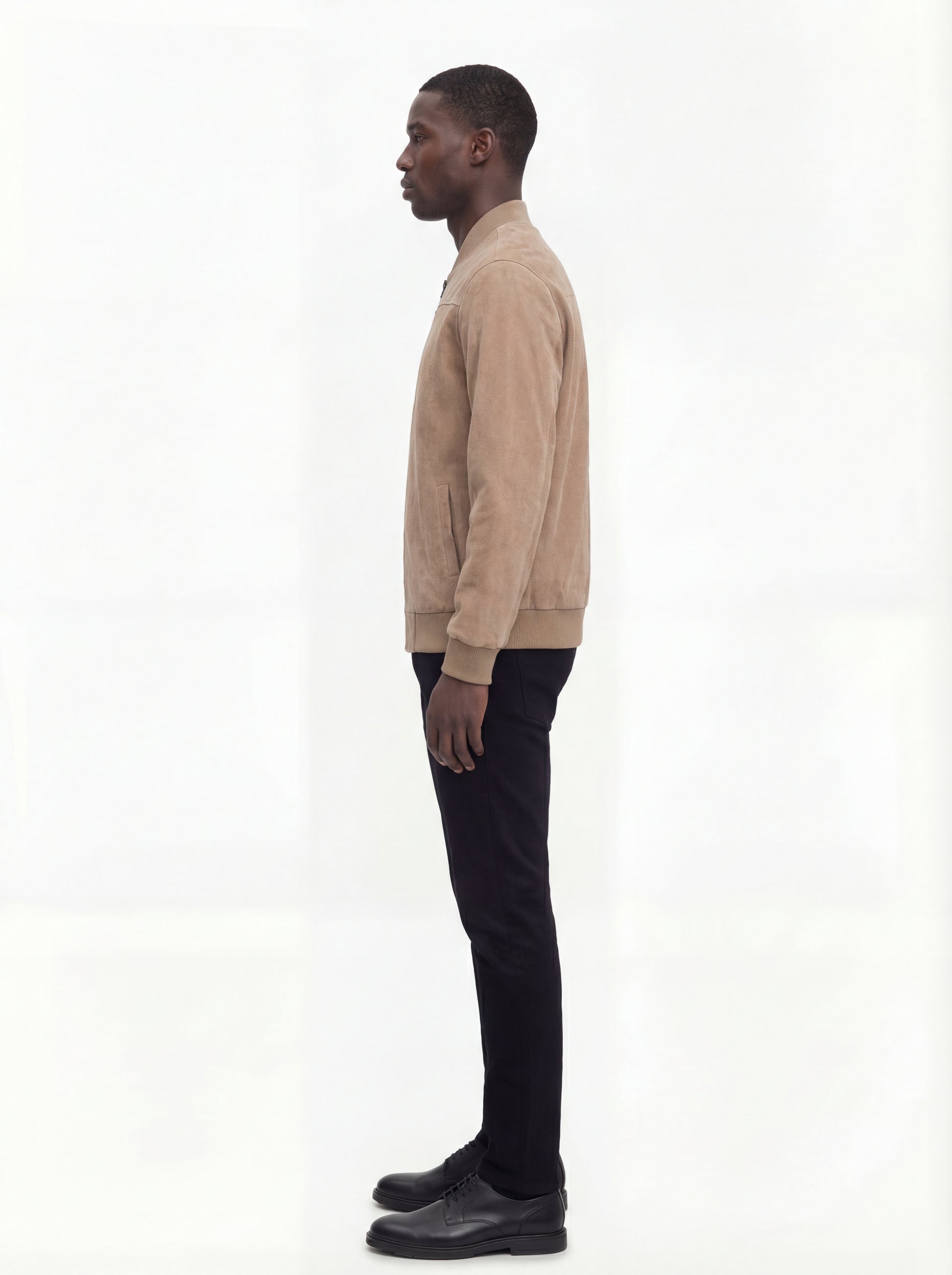 Side profile of Maverick Cian suede bomber jacket showing ribbed sleeve cuffs and classic bomber silhouette. Maverick Jacket.