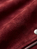 Macro shot of soft burgundy suede texture and silver zipper hardware on biker jacket. The Ecliptic by Maverick Jacket.