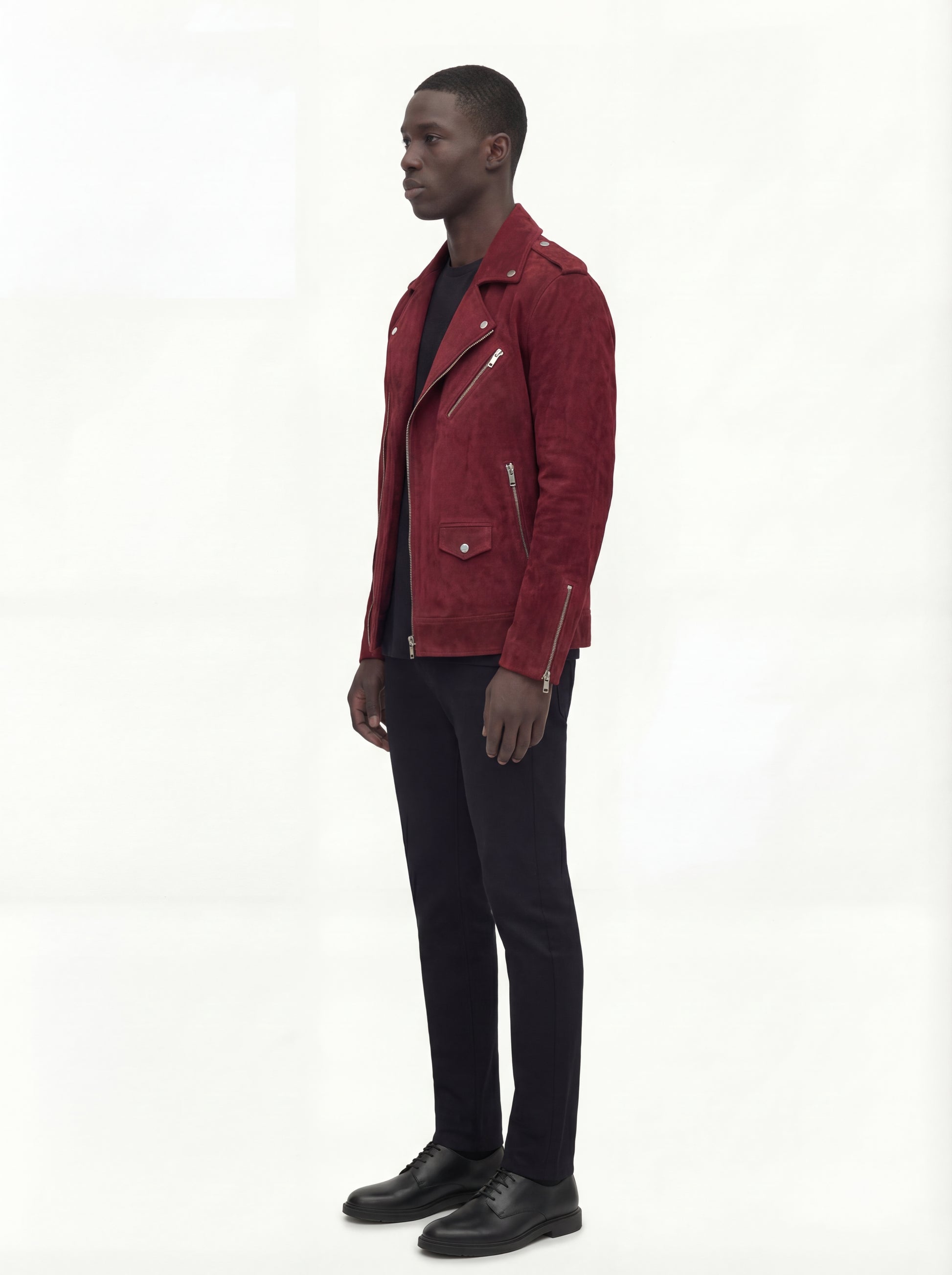 Side profile of Maverick Ecliptic suede biker jacket showing zippered sleeve cuffs and cropped silhouette. Maverick Jacket.