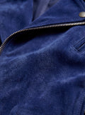 Macro shot of soft blue suede texture and silver zipper hardware on biker jacket. The Aether by Maverick Jacket.