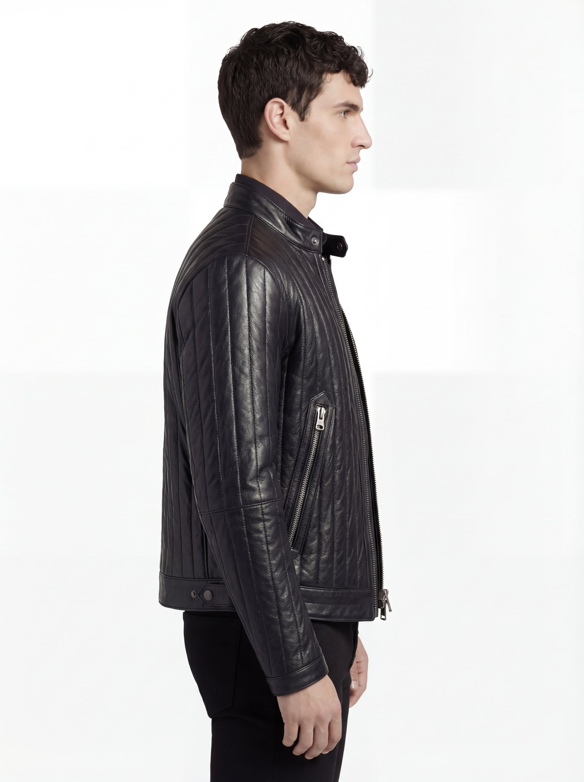Side profile of Maverick Stratos quilted leather jacket showing channel quilted sleeve detail and slim torso fit. Maverick Jacket.
