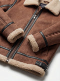 Macro shot of brown suede texture and black leather side buckle strap detail on shearling B3 jacket. The Altitude by Maverick Jacket.