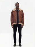 Male model wearing Maverick Altitude shearling B3 jacket, regular fit, styled with black crewneck top and black slim trousers. Maverick Jacket.
