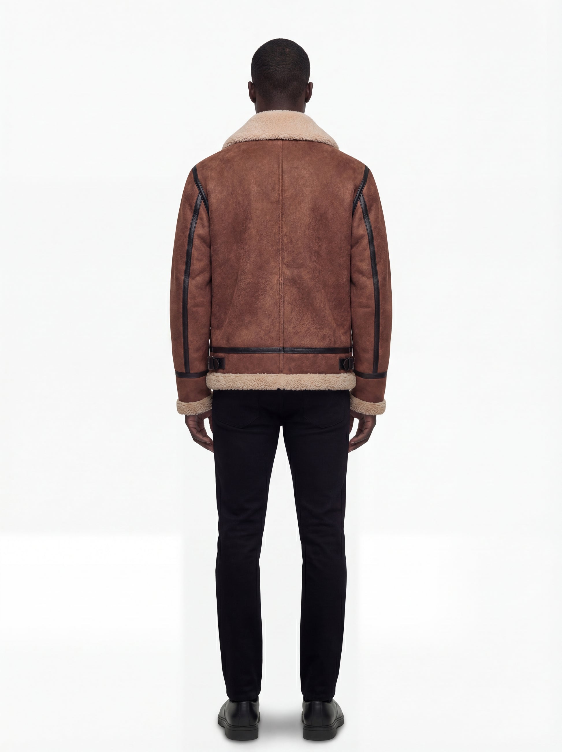 Rear view of male model wearing Maverick Altitude shearling B3 jacket showing structured shoulder fit and shearling-trimmed hem. Maverick Jacket.
