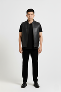 Male model wearing Maverick Jaxon leather vest, regular fit, styled over a grey hoodie with black cargo trousers. Maverick Jacket.