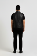 Rear view of male model wearing Maverick Jaxon leather vest showing broad shoulder fit and clean back styling. Maverick Jacket.