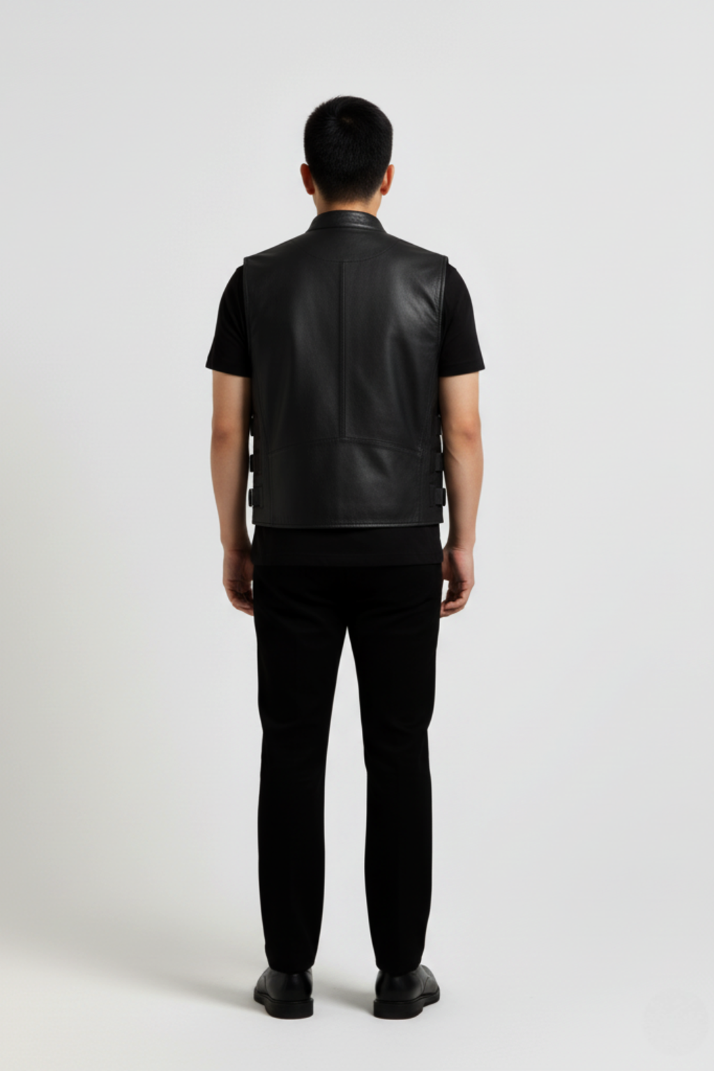 Rear view of male model wearing Maverick Jaxon leather vest showing broad shoulder fit and clean back styling. Maverick Jacket.