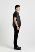 Side profile of Maverick Jaxon leather vest showing sleeveless armhole cut and boxy silhouette. Maverick Jacket.