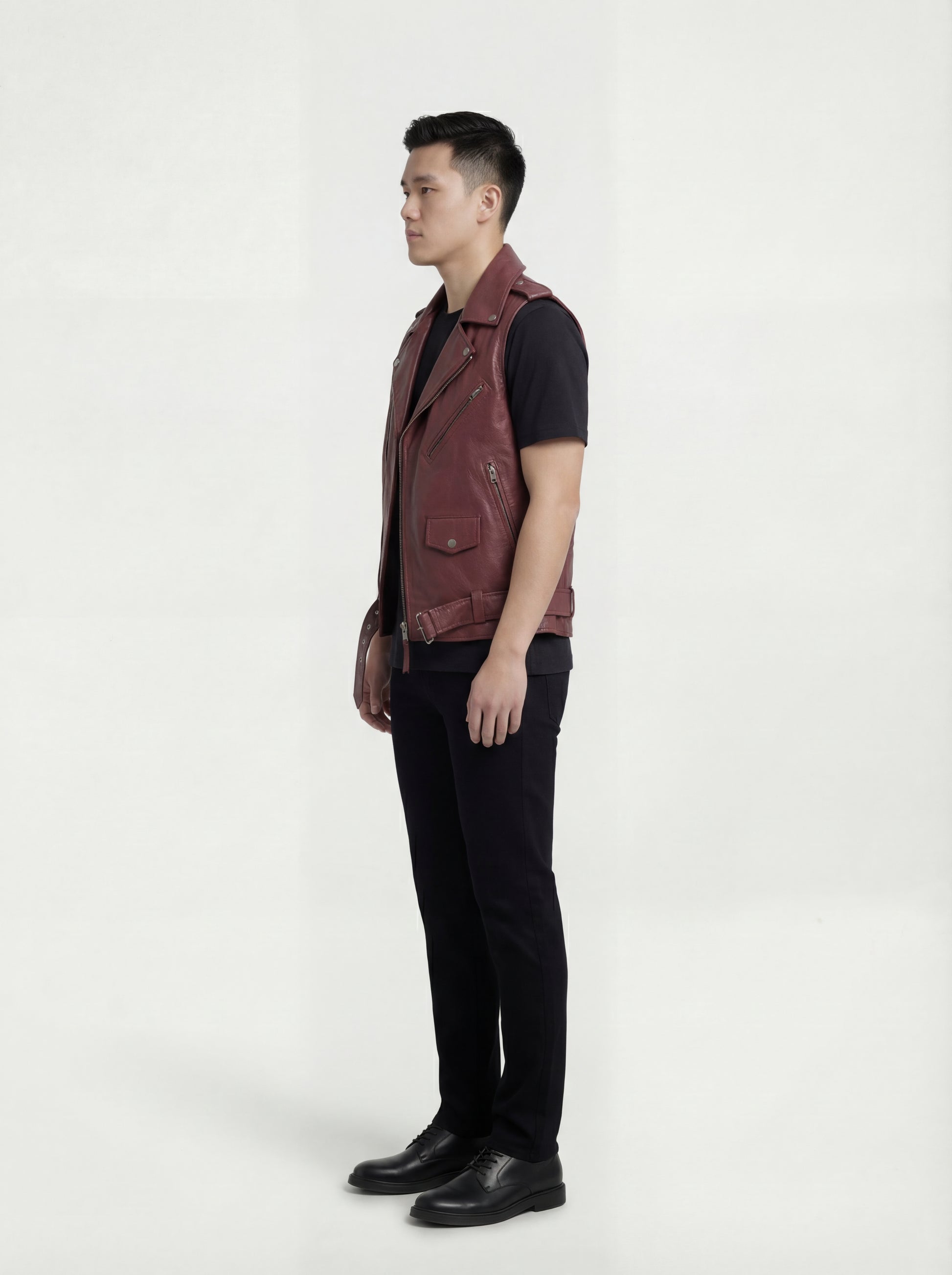 Side profile of Maverick Valor leather biker vest showing deep armhole cut and cropped biker silhouette. Maverick Jacket.