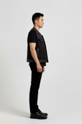 Side profile of Maverick Ryker mixed-media biker vest showing raw edge armholes and cropped biker silhouette. Maverick Jacket.