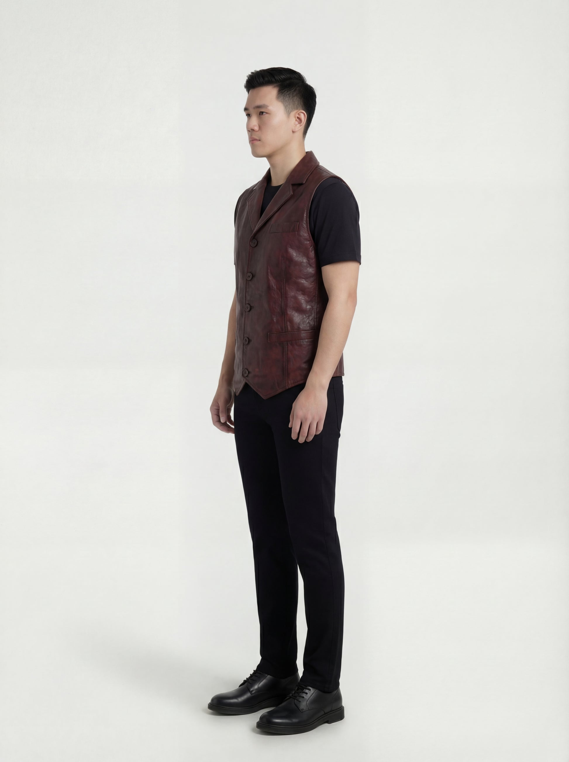 Side profile of Maverick Rook leather button vest showing deep armhole cut and tailored torso silhouette. Maverick Jacket.