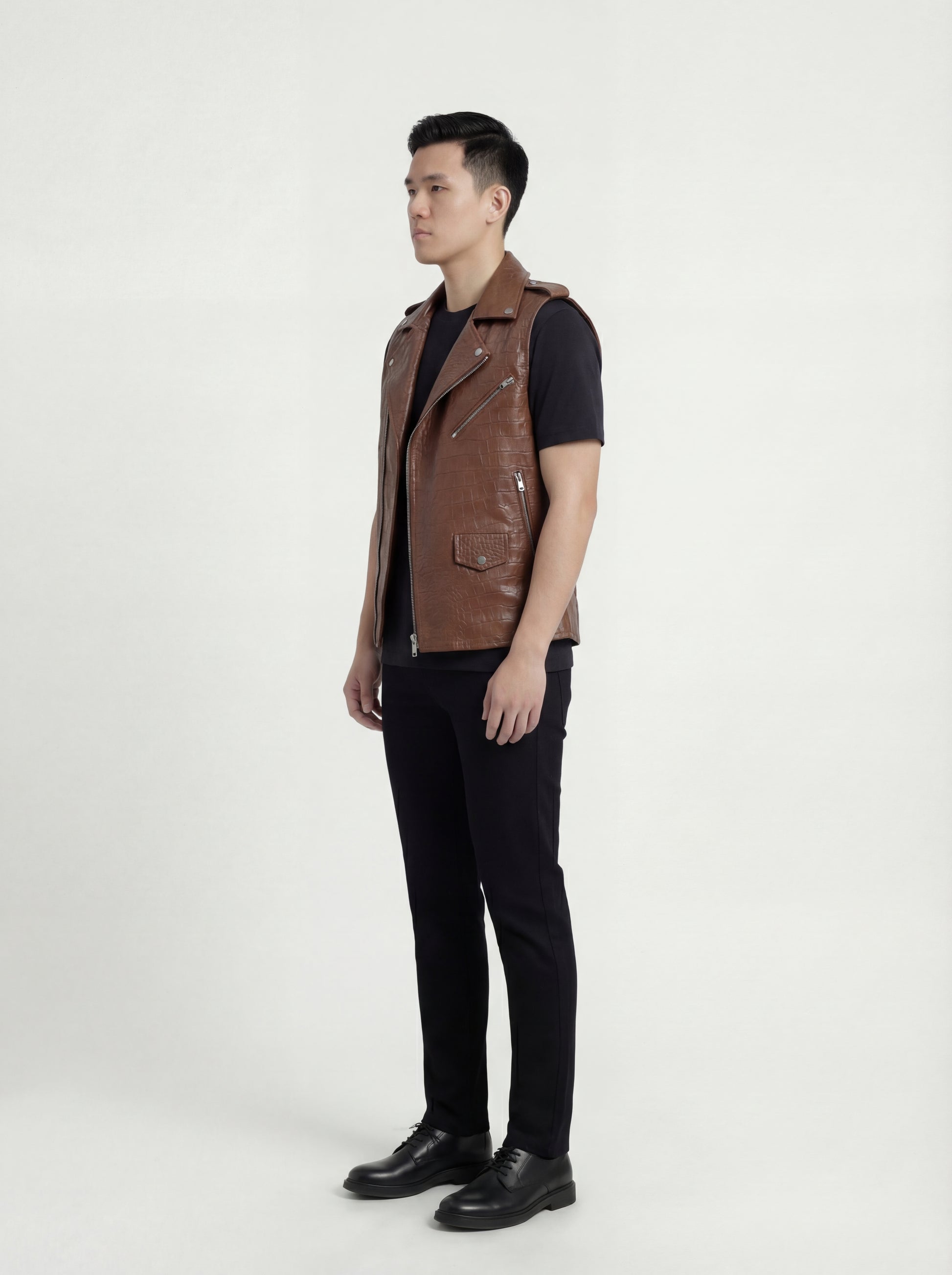 Side profile of Maverick Drake croc-embossed leather biker vest showing deep armhole cut and structured biker silhouette. Maverick Jacket.