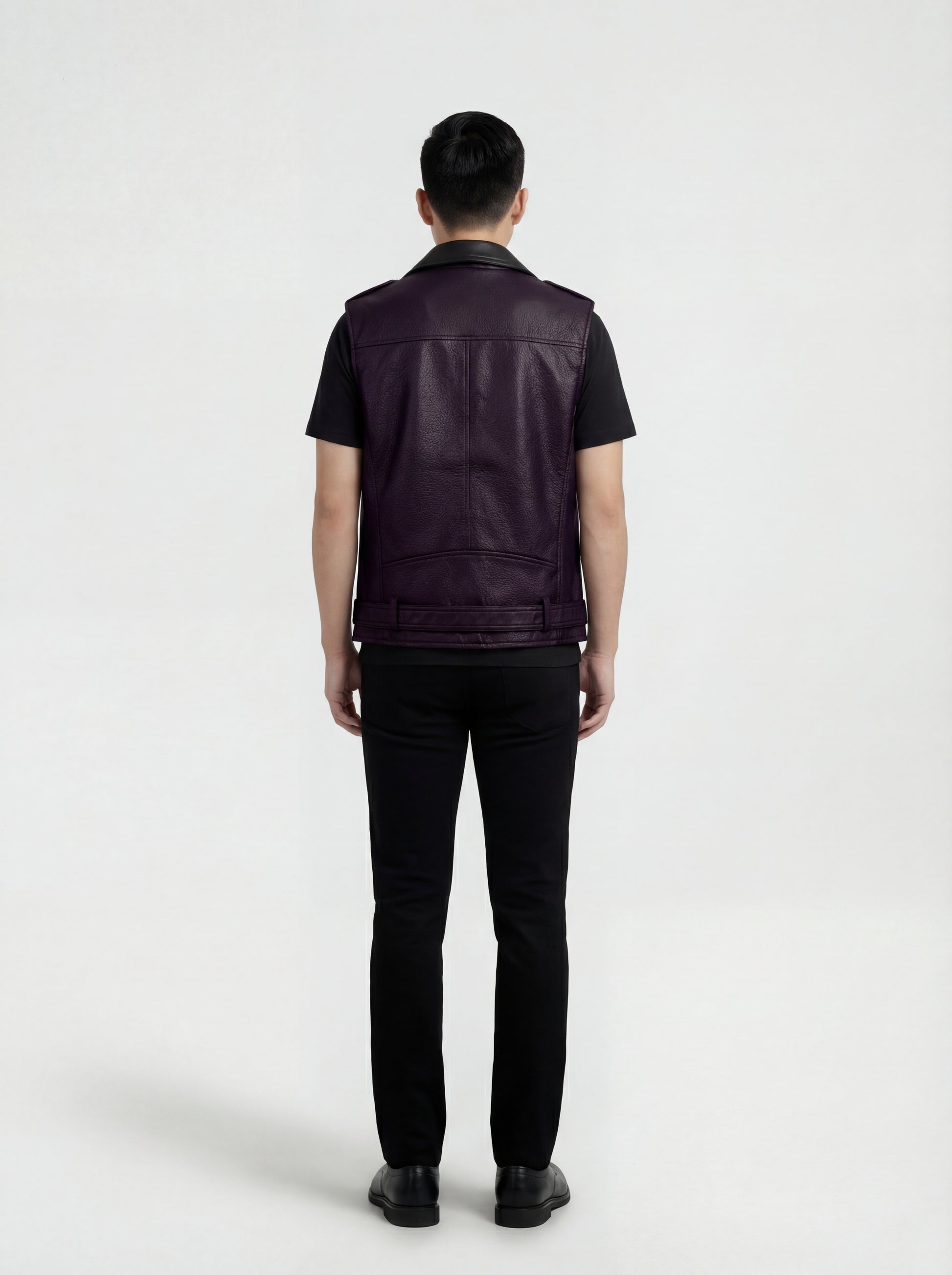 Rear view of male model wearing Maverick Rocco leather biker vest showing broad shoulder fit and clean back yoke styling. Maverick Jacket.
