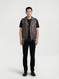 Male model wearing Maverick Vulcan leather biker vest, slim fit, styled over a black hoodie with distressed denim jeans. Maverick Jacket.