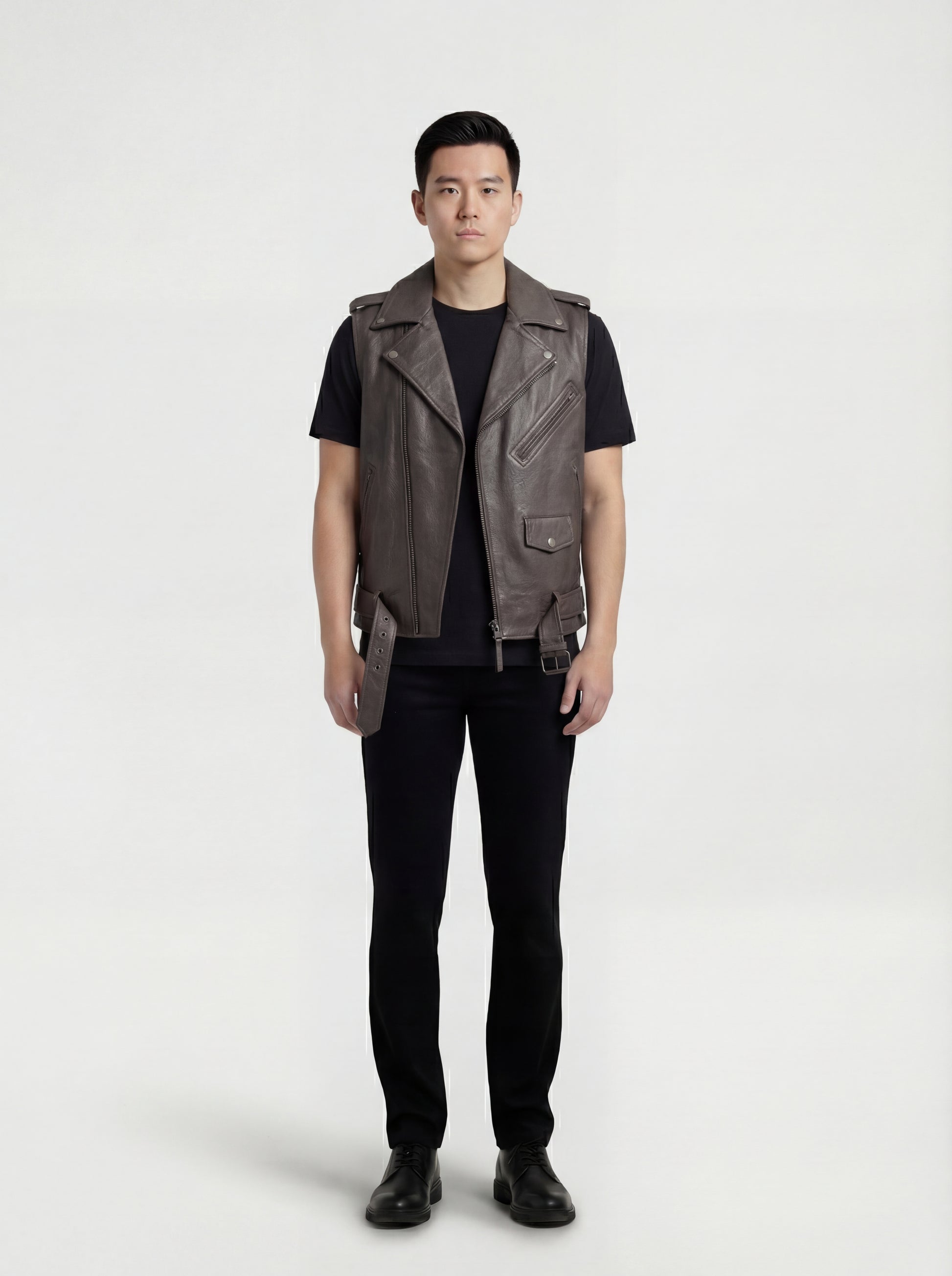Male model wearing Maverick Vulcan leather biker vest, slim fit, styled over a black hoodie with distressed denim jeans. Maverick Jacket.