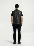 Rear view of male model wearing Maverick Riot leather biker vest showing broad shoulder fit and clean back yoke styling. Maverick Jacket.