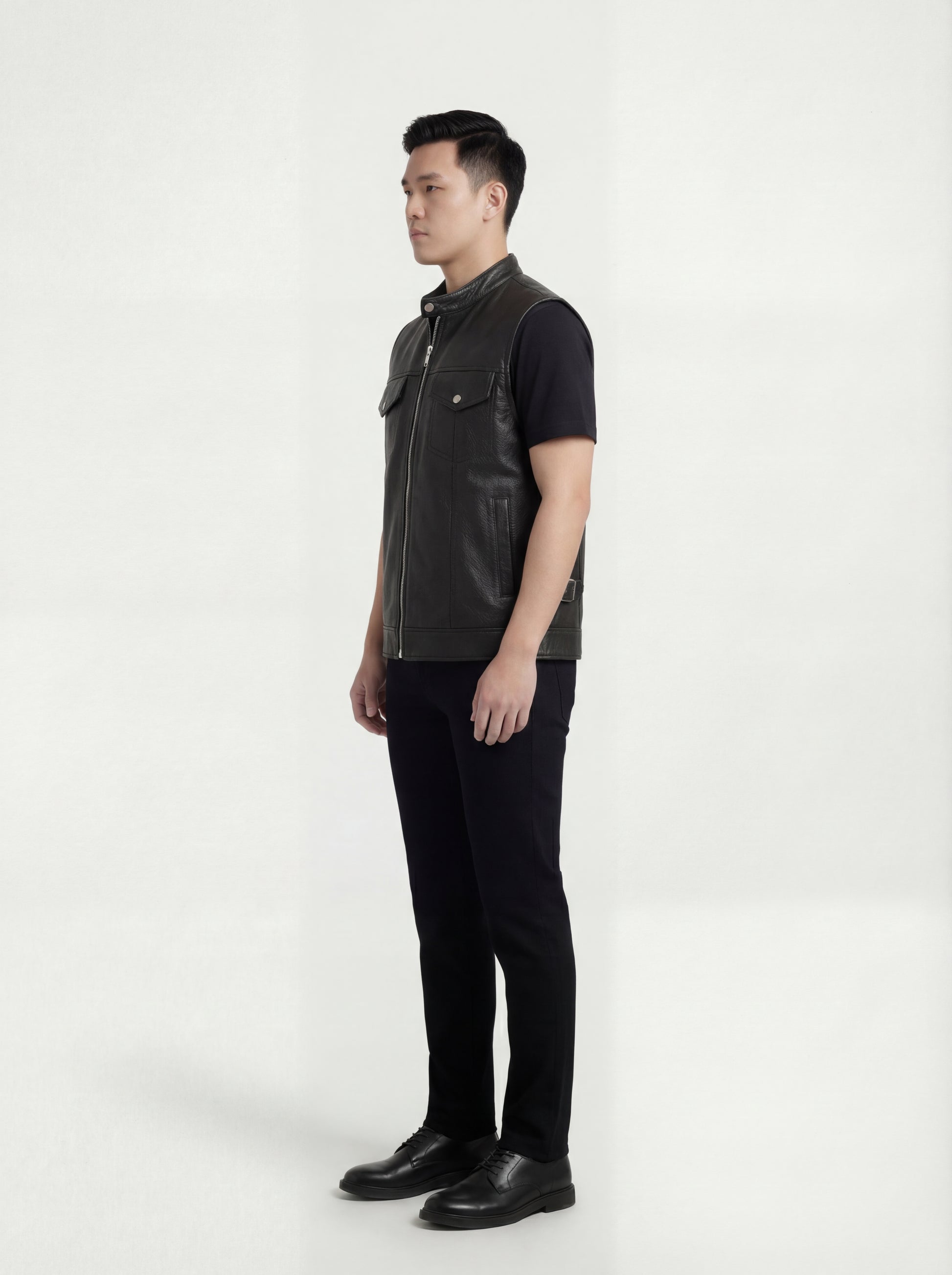 Side profile of Maverick Riot leather biker vest showing deep armhole cut and cropped biker silhouette. Maverick Jacket.