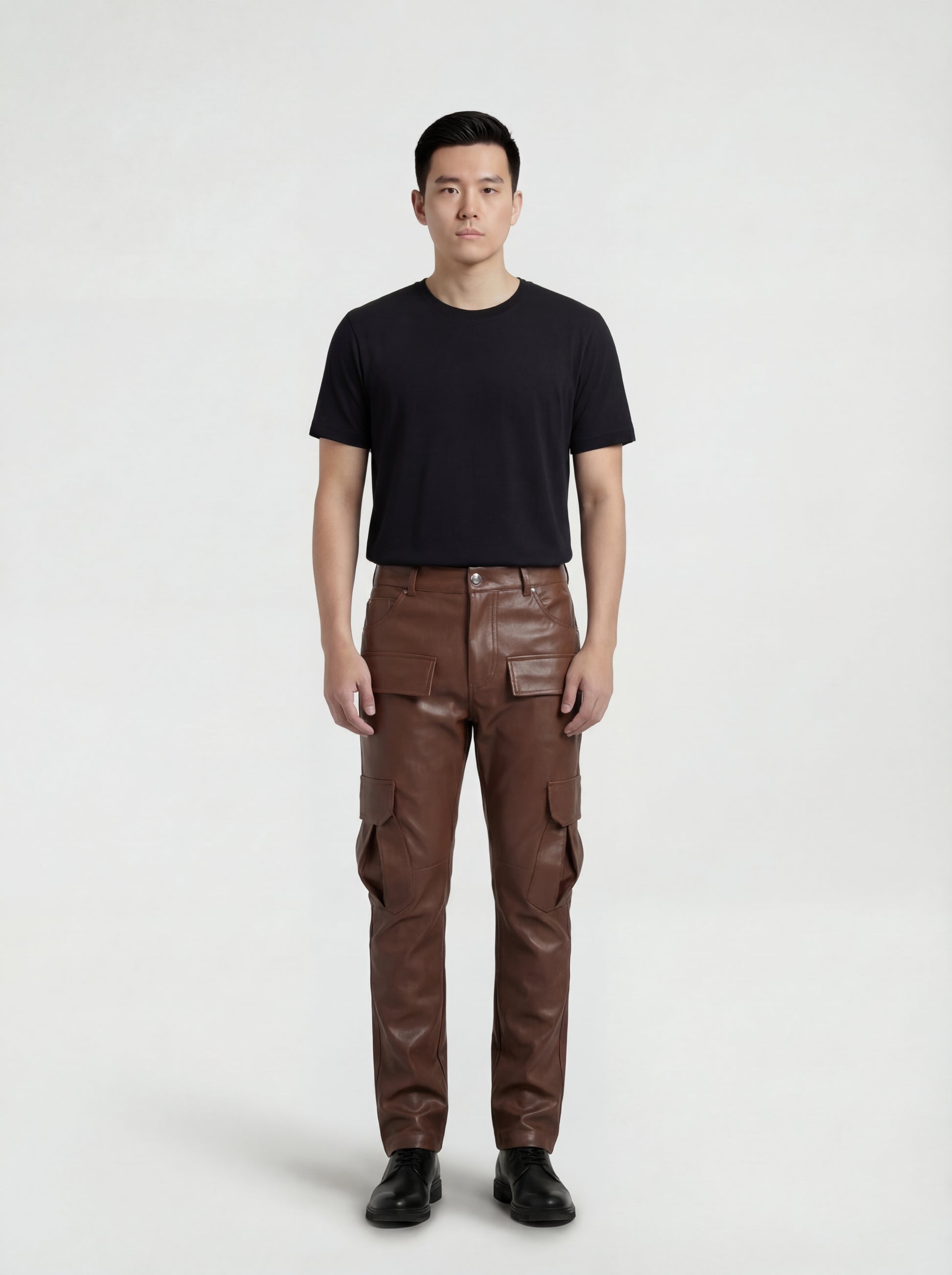 Male model wearing Maverick Cassian leather cargo trousers, regular fit, styled with black crewneck t-shirt. Maverick Jacket.