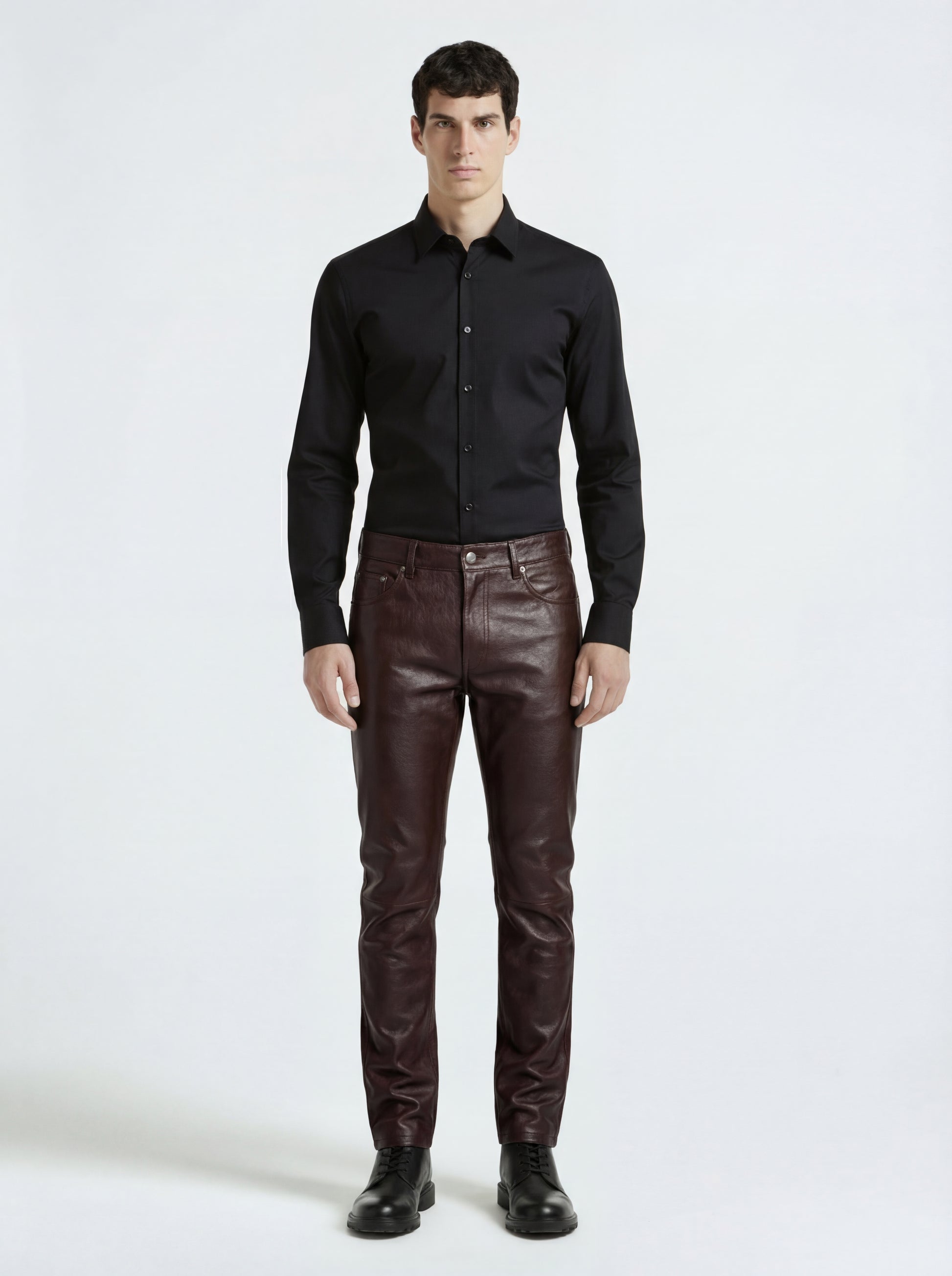 Male model wearing Maverick Kade leather trousers, slim fit, styled with black long-sleeve button-up shirt. Maverick Jacket.