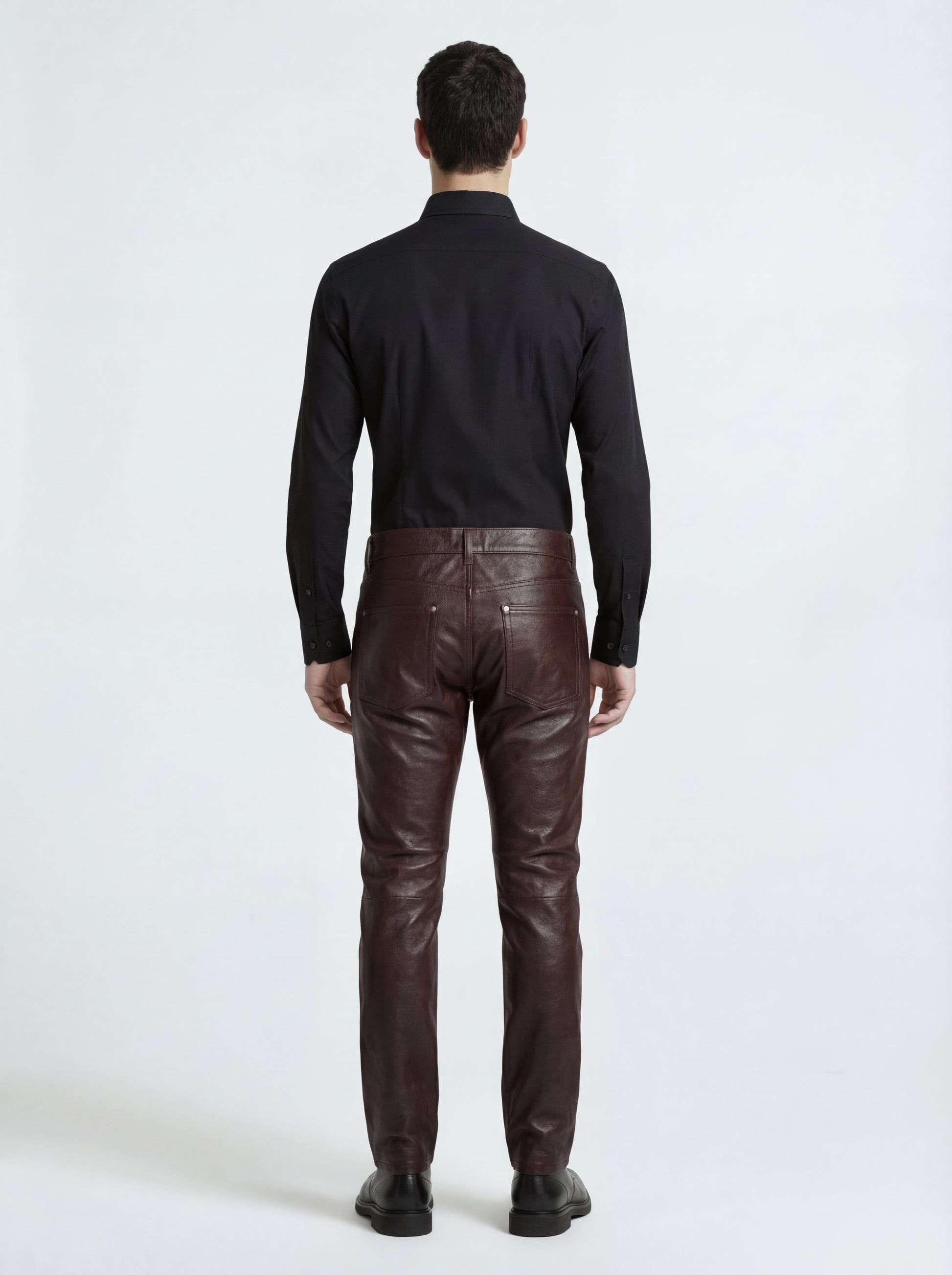 Rear view of male model wearing Maverick Kade leather trousers showing form-fitting seat and straight leg structure. Maverick Jacket.