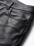 Macro shot of black pebbled leather grain and pocket rivet detail on pant. The Caliber by Maverick Jacket.