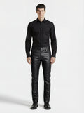 Male model wearing Maverick Caliber black pebbled leather pant, slim fit, styled with black button-up shirt and black leather boots. Maverick Jacket.