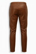 Rear view of brown leather jogger pants showing rear welt pockets and elasticated waistband. The Caelan by Maverick Jacket.