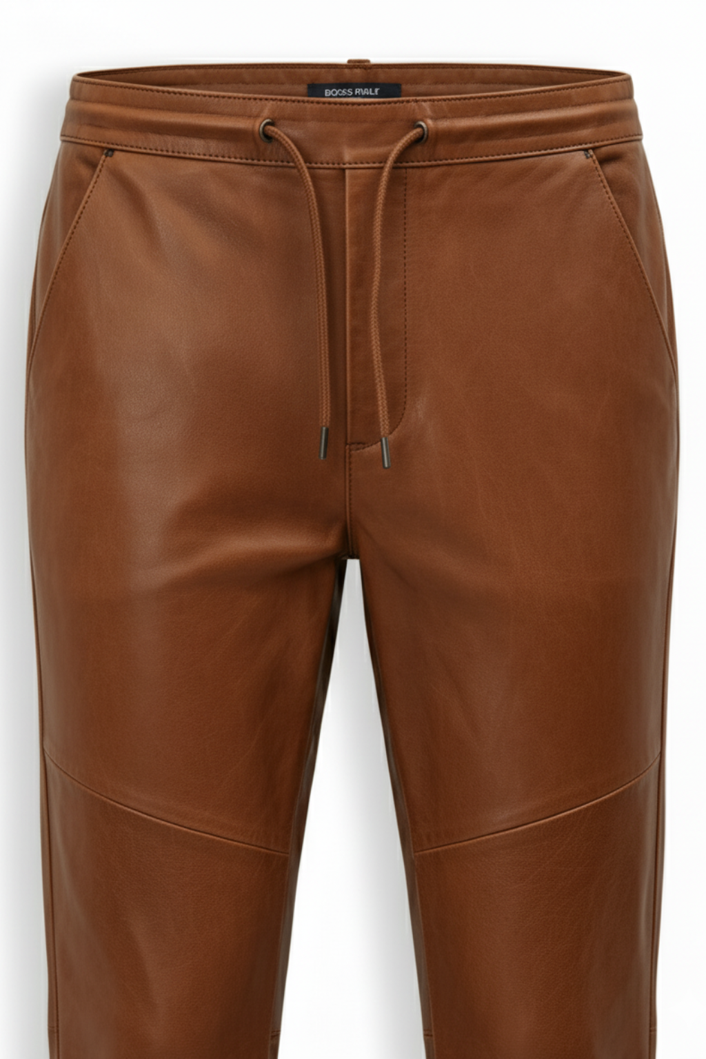 Macro shot of smooth brown leather grain and slanted pocket stitching on jogger pants. The Caelan by Maverick Jacket.
