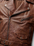 Macro shot of distressed brown leather grain and silver zipper hardware on biker jacket. The Apex by Maverick Jacket.
