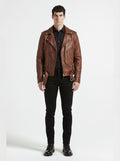 Male model wearing Maverick Apex brown leather biker jacket, slim fit, styled with black button-up shirt and black skinny jeans. Maverick Jacket.