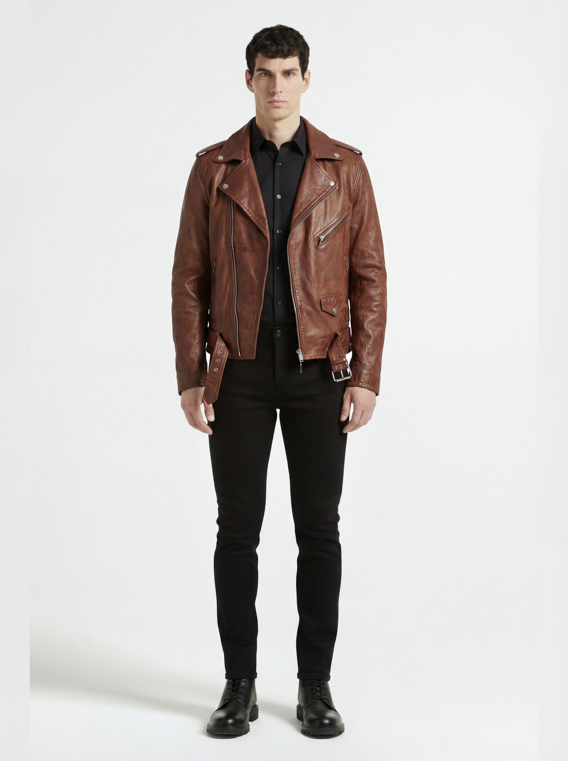 Male model wearing Maverick Apex brown leather biker jacket, slim fit, styled with black button-up shirt and black skinny jeans. Maverick Jacket.