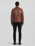 Rear view of male model wearing Maverick Apex brown leather biker jacket showing fitted shoulder width and straight hem. Maverick Jacket.