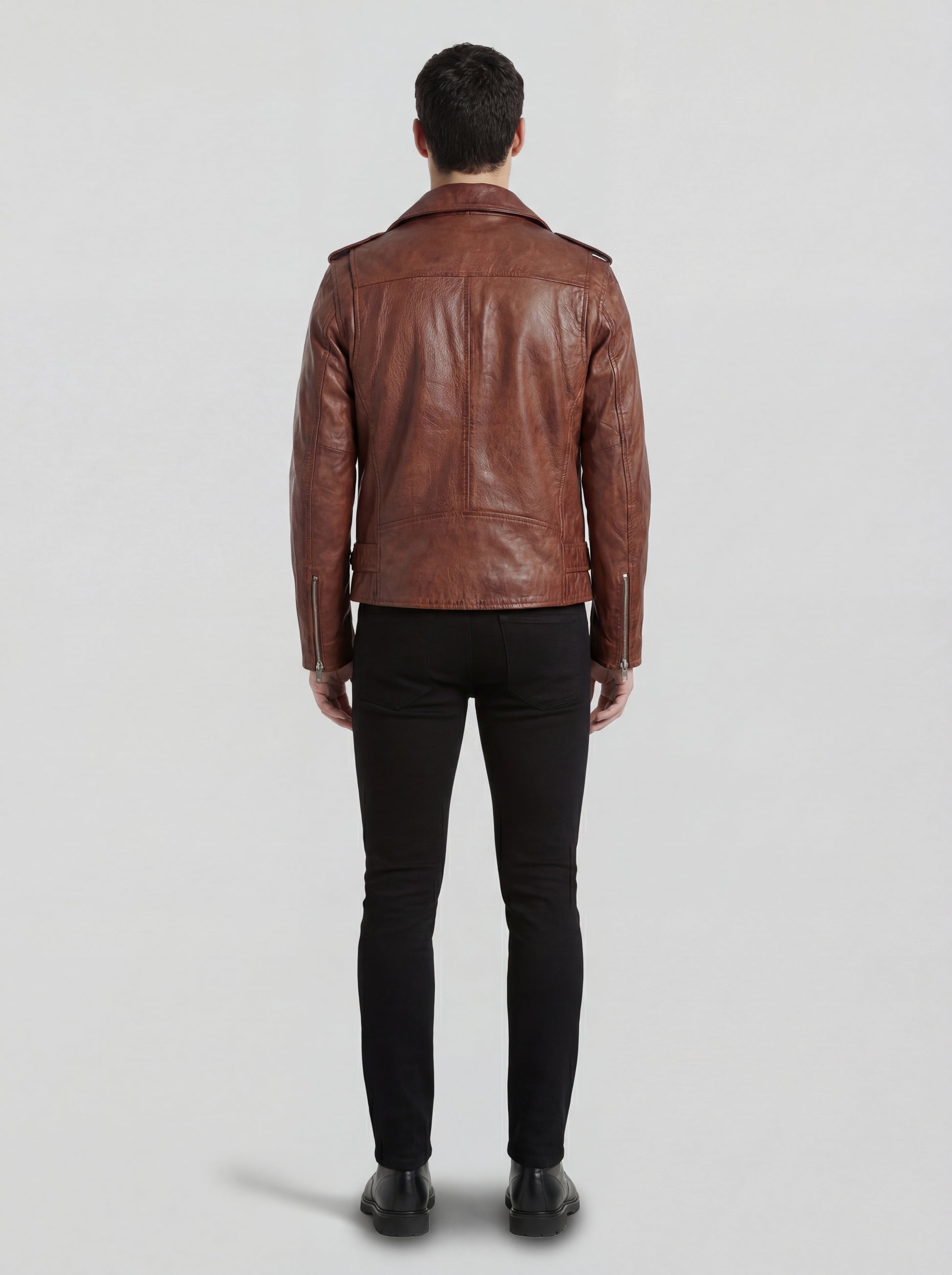 Rear view of male model wearing Maverick Apex brown leather biker jacket showing fitted shoulder width and straight hem. Maverick Jacket.