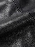 Macro shot of pebbled black leather texture and reinforced seam stitching on car coat. The Hawk by Maverick Jacket.