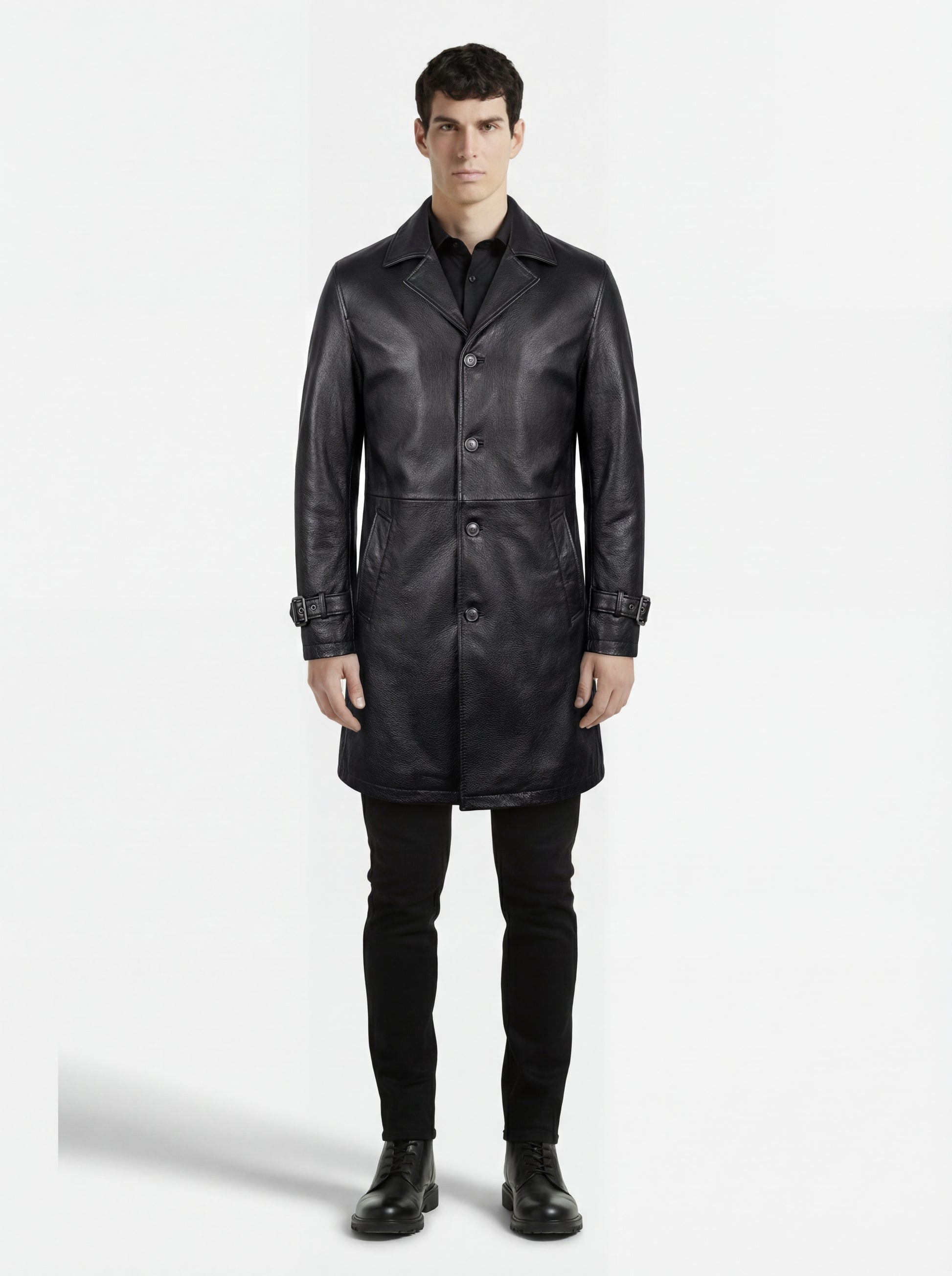 Male model wearing Maverick Hawk leather car coat, tailored fit, styled with black button-down shirt and black slim-fit jeans. Maverick Jacket.