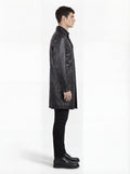 Side profile of Maverick Hawk leather car coat showing long sleeve structure with cuff strap and straight mid-length silhouette. Maverick Jacket.