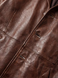 Macro shot of heavy-grain pebbled leather texture and buttonhole stitching on coat. The Consul by Maverick Jacket.