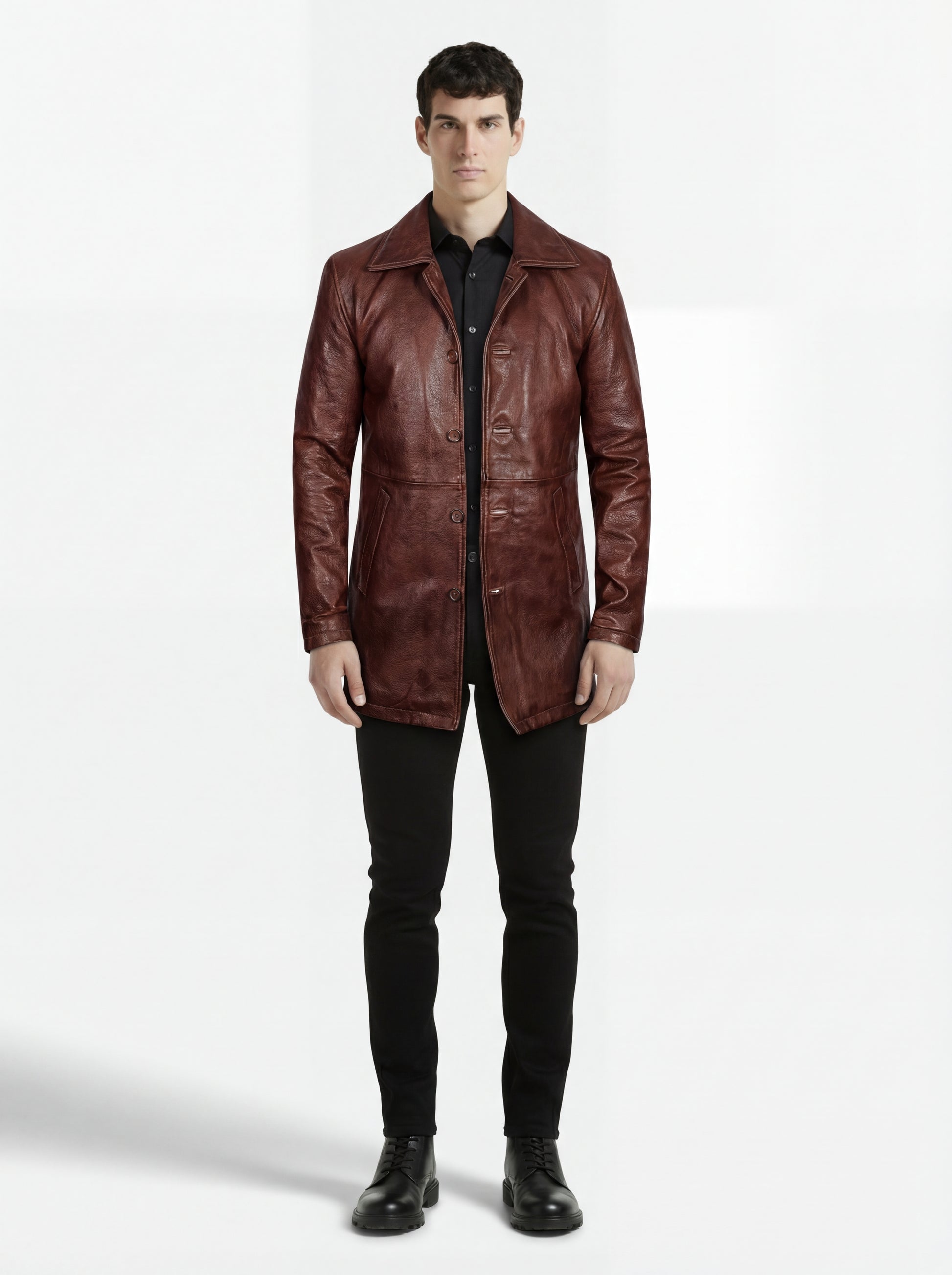 Male model wearing Maverick Consul leather coat, tailored fit, styled with black button-down shirt and black skinny jeans. Maverick Jacket.