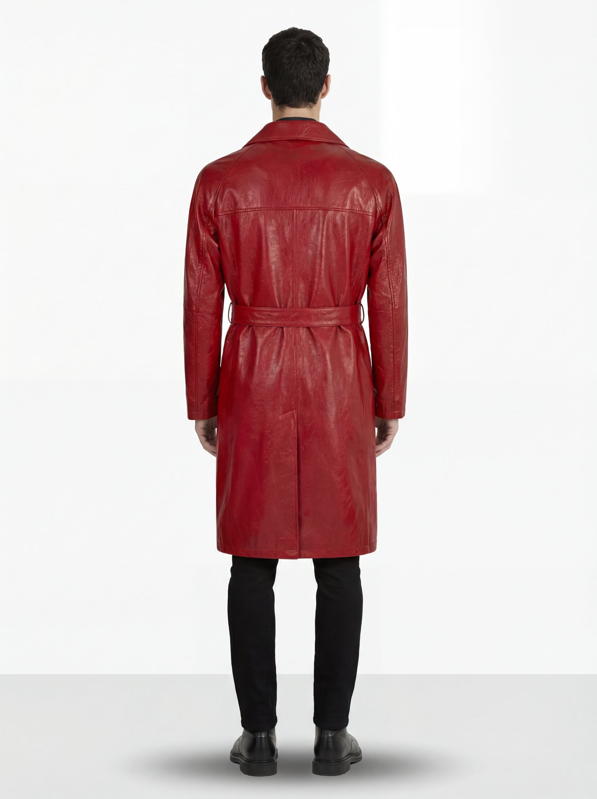Rear view of male model wearing Maverick Valerian leather trench coat showing structured shoulder drape and belted back styling. Maverick Jacket.