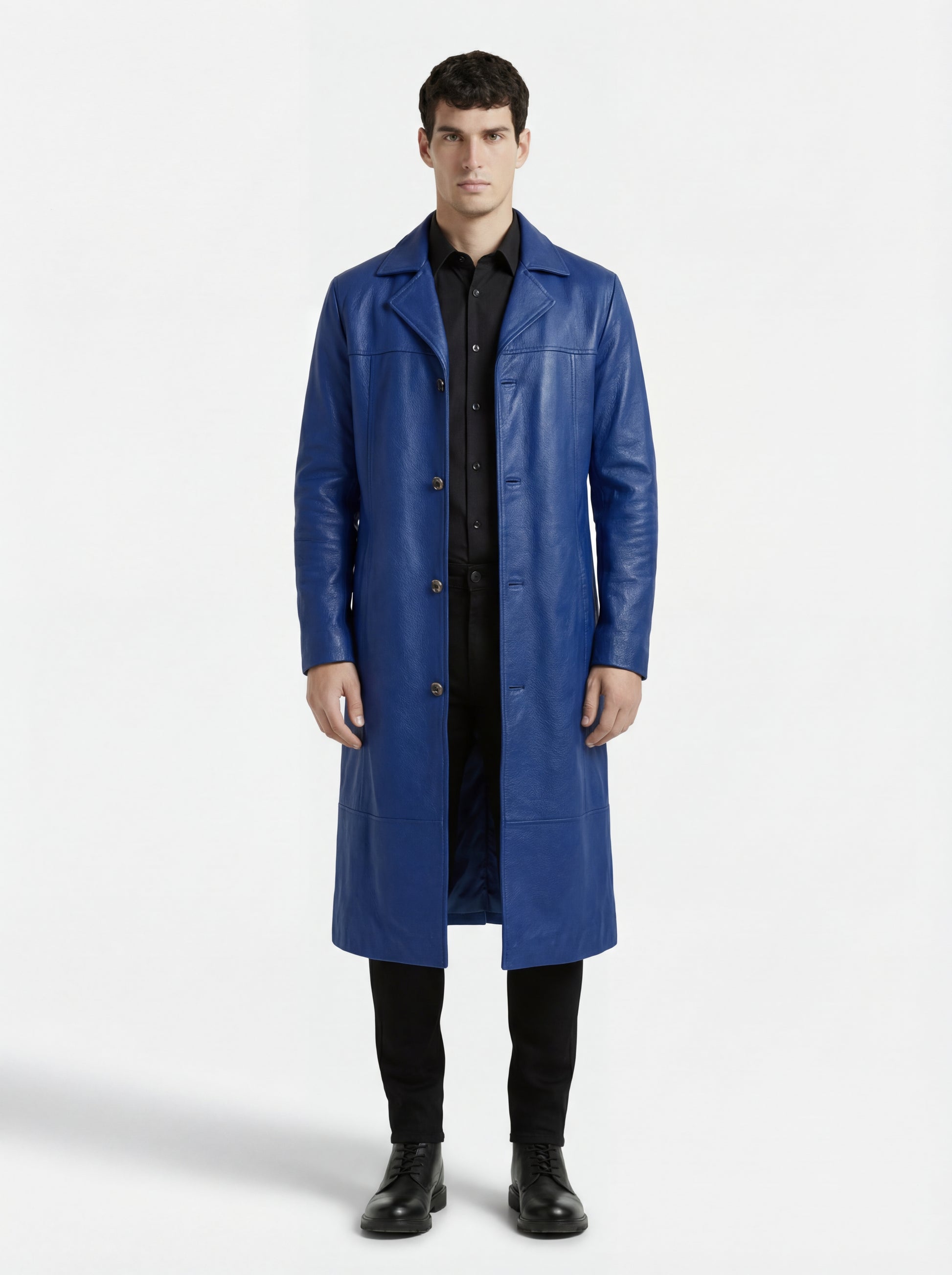 Male model wearing Maverick Regent leather Mac Coat, tailored fit, styled with black button-down shirt and black slim-fit trousers. Maverick Jacket.