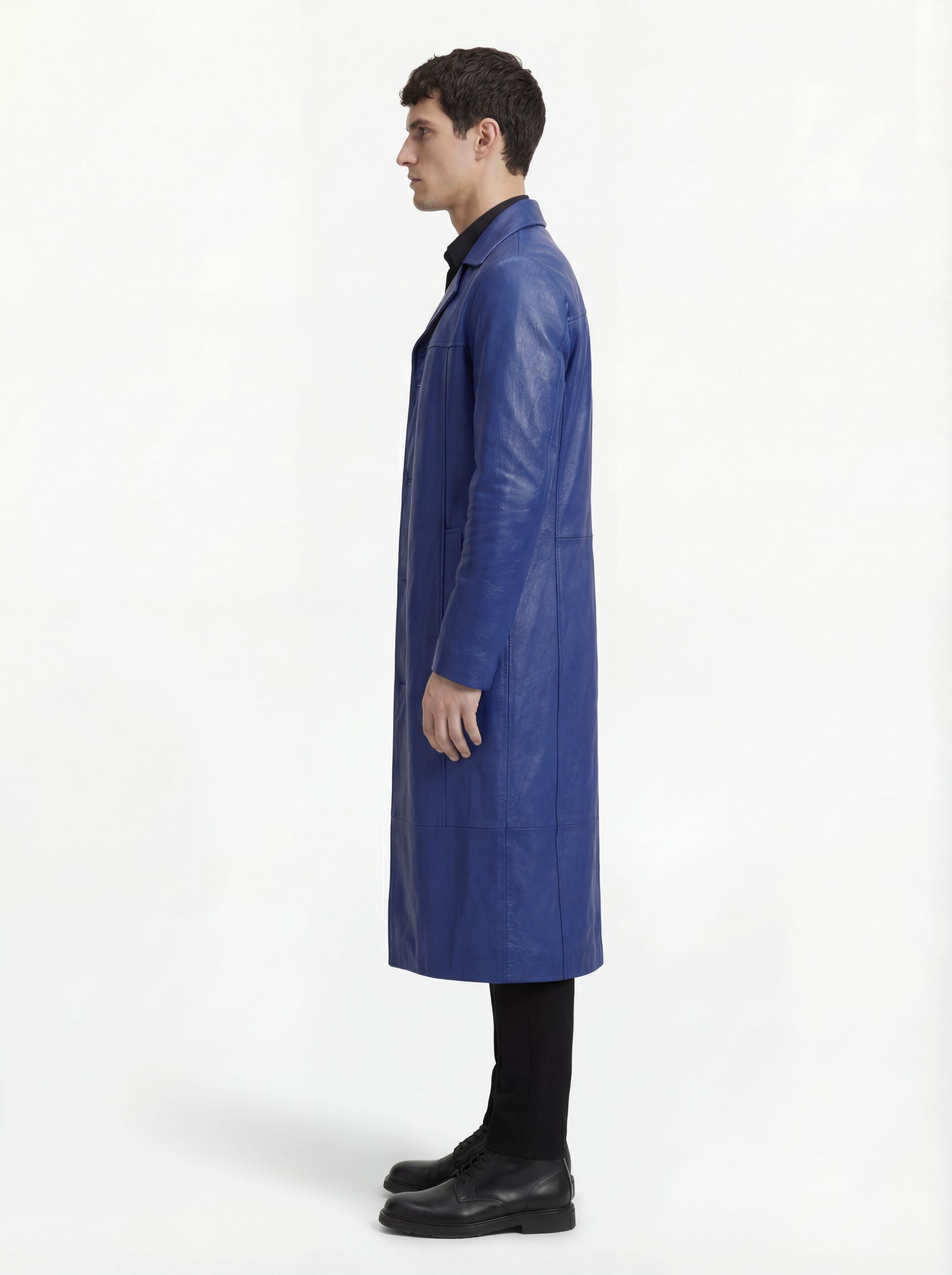 Side profile of Maverick Regent leather Mac Coat showing set-in sleeve structure and straight longline silhouette. Maverick Jacket.